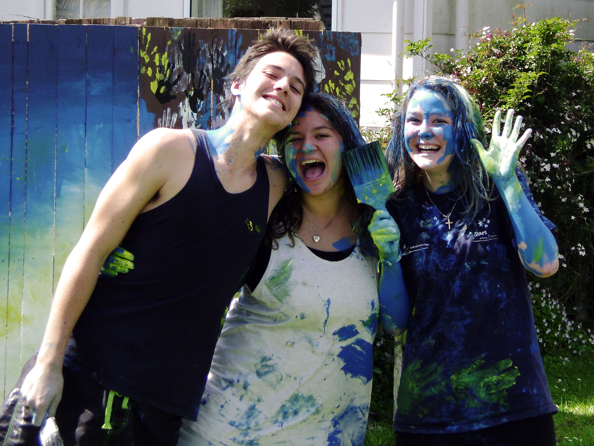 Girls covered in blue paint after an activity day
