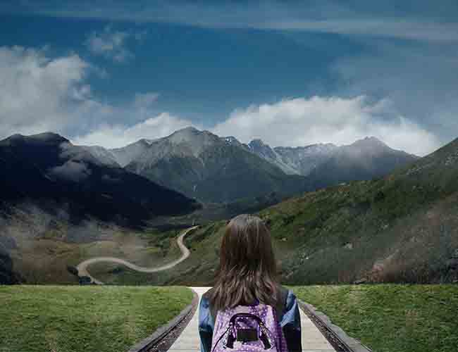 Girl walking towards mountain