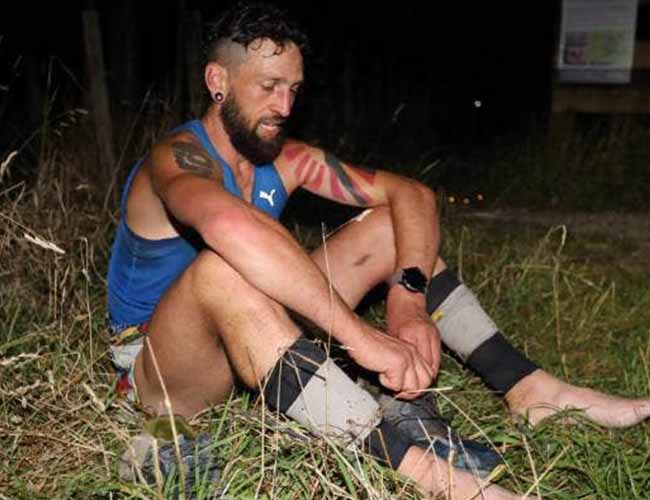Michael Stuart sitting in grass after his run